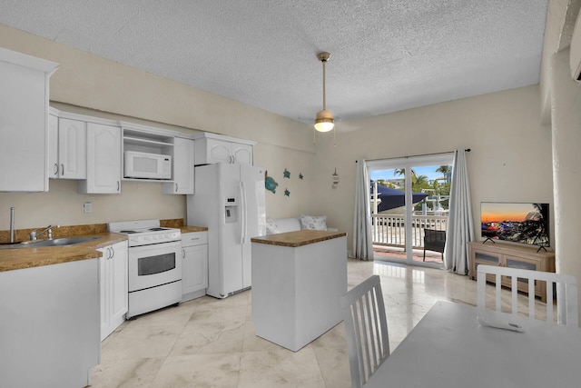 kitchen with a sink, white appliances, marble finish floor, and white cabinetry