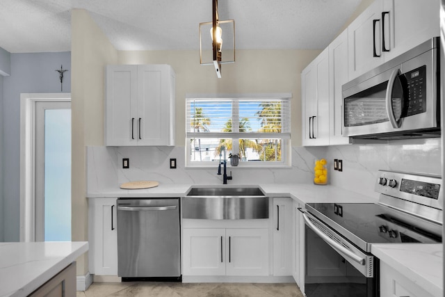 kitchen featuring a sink, stainless steel appliances, light stone counters, and backsplash