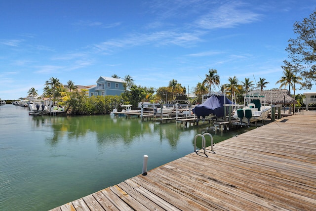 dock area with boat lift and a water view