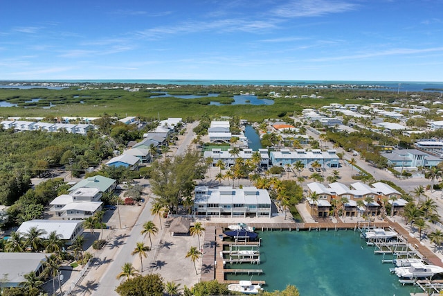 birds eye view of property with a water view and a residential view