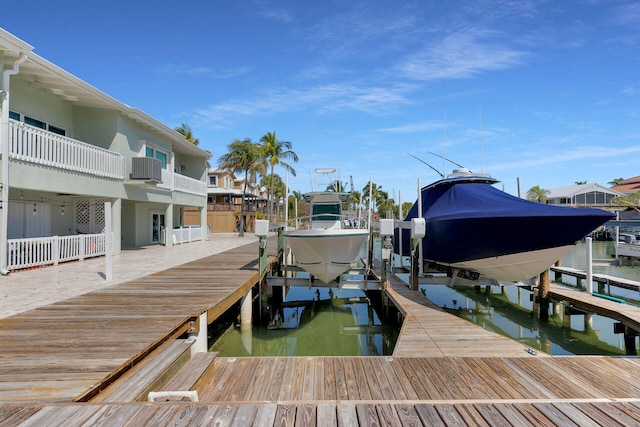 dock area featuring central air condition unit, a water view, and boat lift