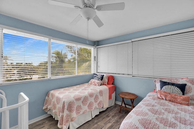 bedroom featuring ceiling fan, baseboards, and wood finished floors