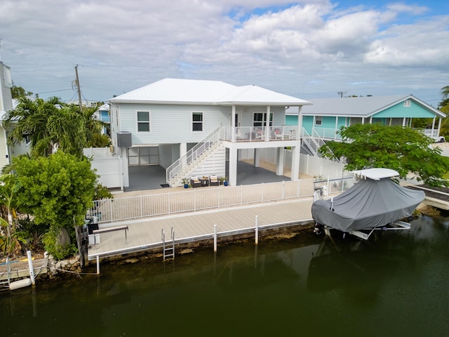 rear view of house featuring a water view