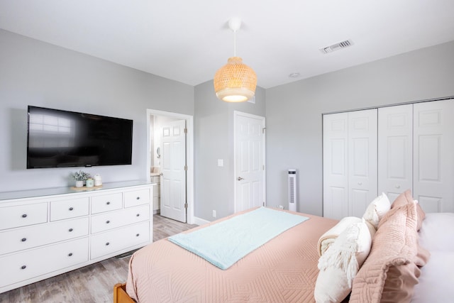 bedroom featuring light hardwood / wood-style floors and a closet