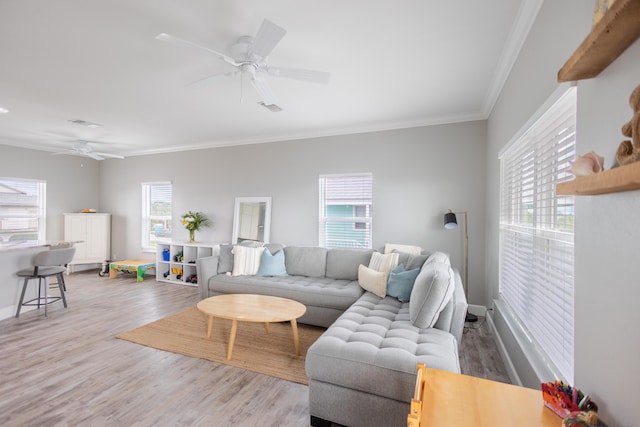 living room with a healthy amount of sunlight, hardwood / wood-style floors, and ceiling fan