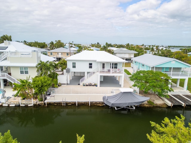 back of property featuring a water view