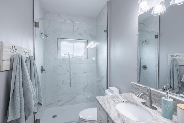 bathroom featuring vanity, toilet, and a shower with shower door