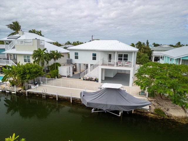 rear view of property with a water view