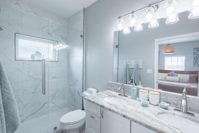 bathroom featuring an enclosed shower, vanity, and toilet