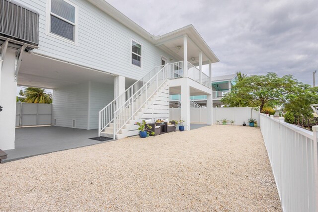 exterior space with central AC and a carport