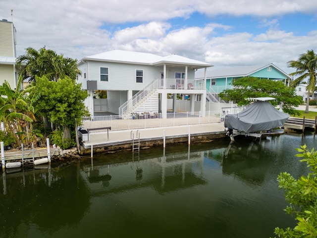 back of property featuring a water view