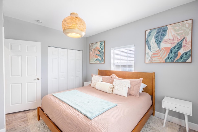 bedroom with a closet and light wood-type flooring