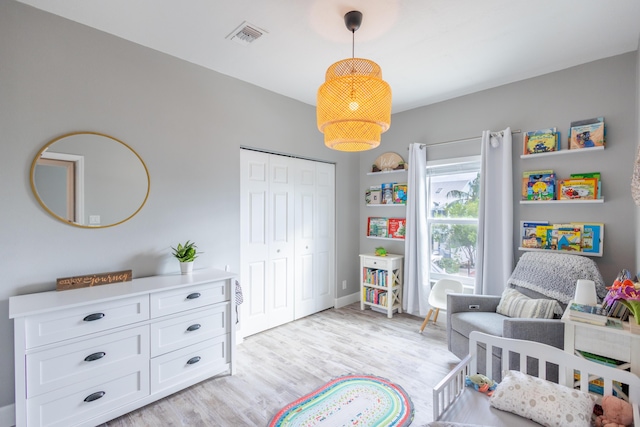 bedroom with a closet and light hardwood / wood-style flooring