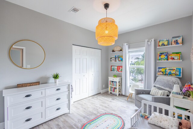 bedroom with a closet and light hardwood / wood-style flooring