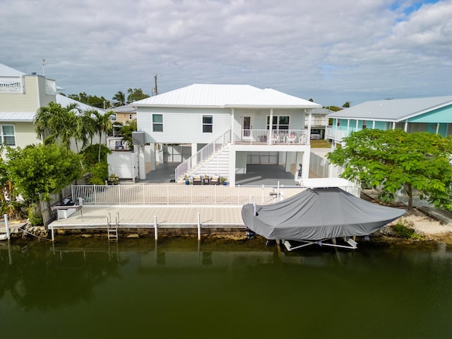 rear view of property with a water view