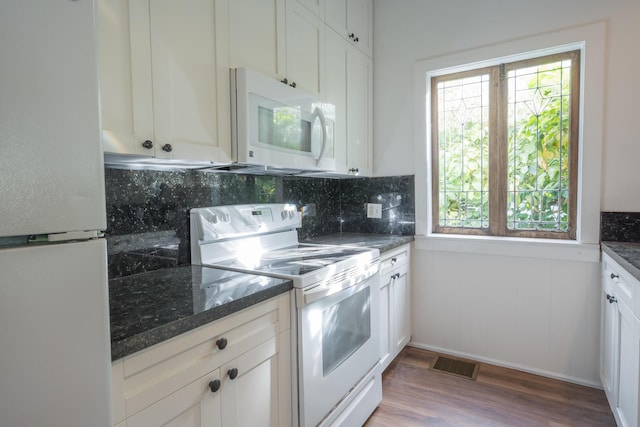 1210 Virginia St, Key West, FL 33040 - kitchen featuring white appliances, healthy amount of natural light, wood finished floors, and backsplash