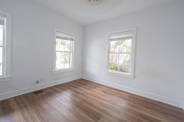 1210 Virginia St, Key West, FL 33040 - spare room featuring dark wood-type flooring, healthy amount of natural light, and baseboards