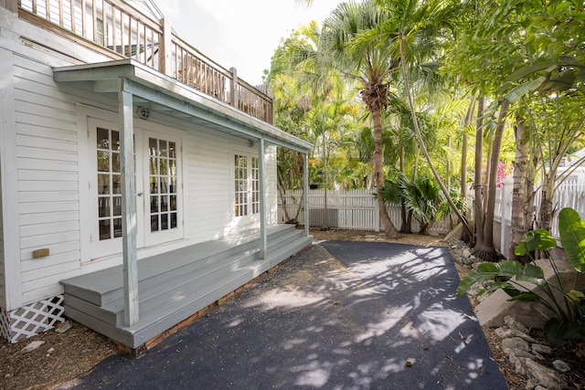 1210 Virginia St, Key West, FL 33040 - view of side of home featuring french doors, fence, a balcony, and a patio area