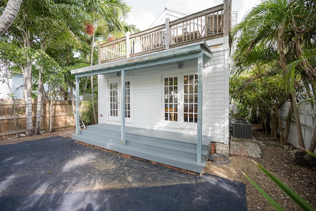 1210 Virginia St, Key West, FL 33040 - rear view of house with a balcony, fence, central AC unit, and french doors