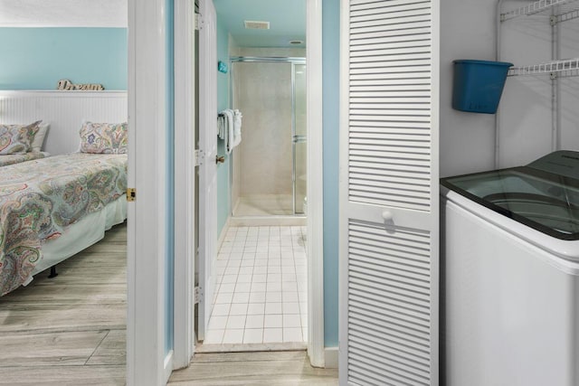 interior space with washer / clothes dryer and light hardwood / wood-style flooring