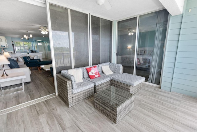 wooden deck with ceiling fan and outdoor lounge area