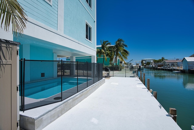 view of swimming pool featuring a water view