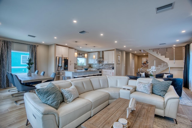 living room with a wealth of natural light and light hardwood / wood-style floors