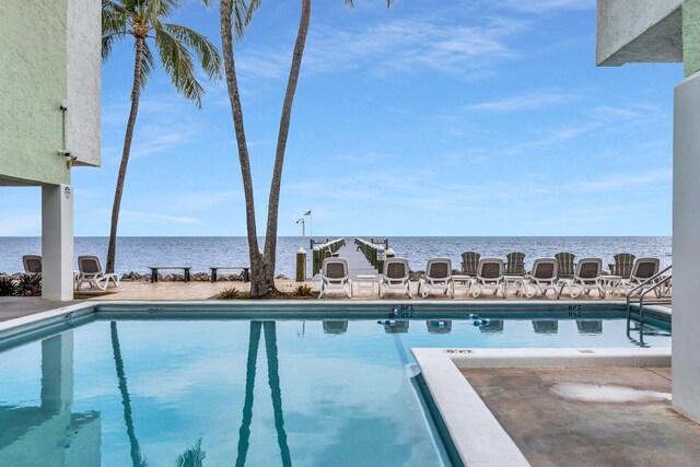 view of swimming pool featuring a water view