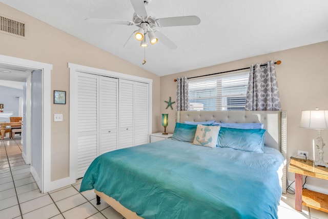 97 Coral Ln, Key Colony, FL 33051 - bedroom with light tile patterned floors, vaulted ceiling, a closet, and a ceiling fan
