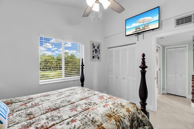 tiled bedroom featuring ceiling fan and a closet