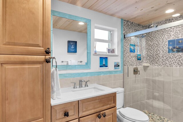 bathroom featuring walk in shower, toilet, wood ceiling, tile walls, and vanity