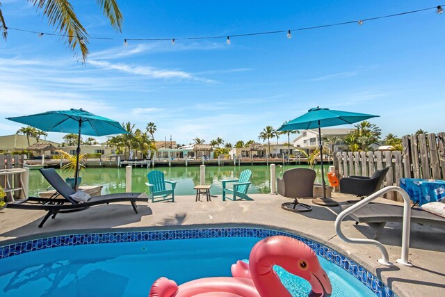 351 8th St, Key Colony, FL 33051 - view of swimming pool featuring a patio, a water view, and fence