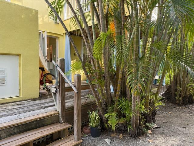 804 S St Unit 1, Key West, FL 33040 - doorway to property featuring stucco siding and a wooden deck