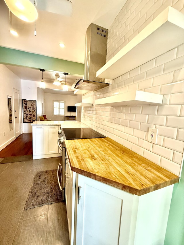 804 S St Unit 1, Key West, FL 33040 - kitchen featuring butcher block counters, wall chimney exhaust hood, open floor plan, stainless steel electric stove, and decorative backsplash