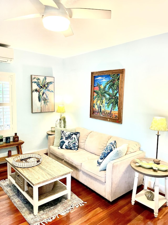 living area featuring a ceiling fan, a wall unit AC, and wood finished floors