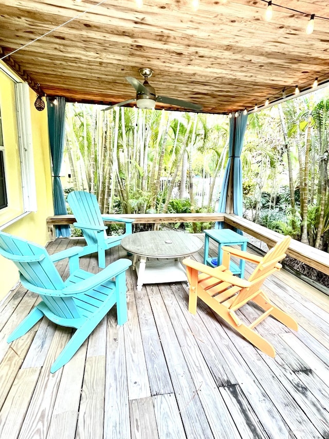 wooden terrace with a ceiling fan