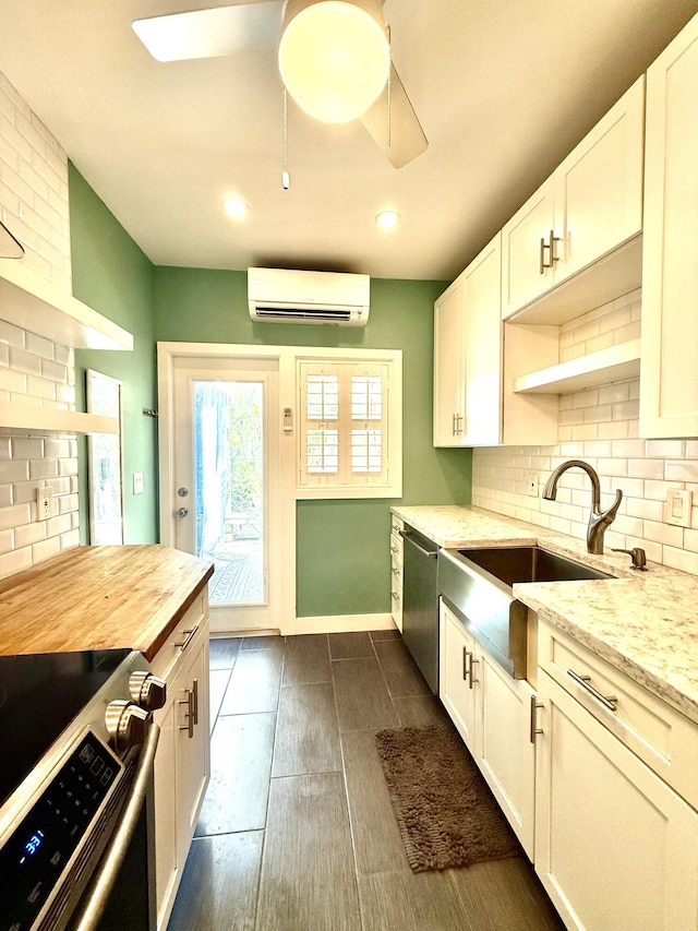 804 S St Unit 1, Key West, FL 33040 - kitchen with stainless steel appliances, a wall unit AC, decorative backsplash, a sink, and a ceiling fan