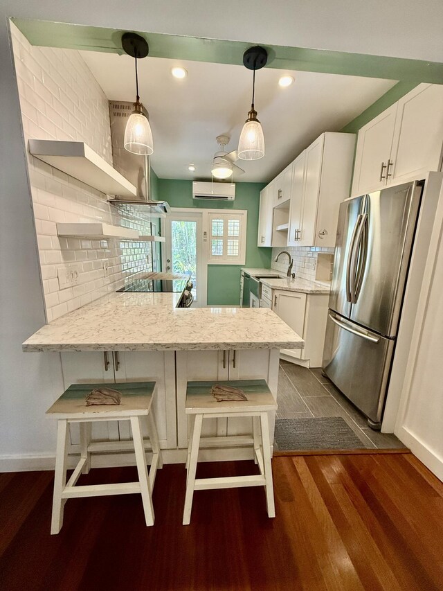 804 S St Unit 1, Key West, FL 33040 - kitchen with freestanding refrigerator, a wall mounted AC, dark wood finished floors, open shelves, and a sink