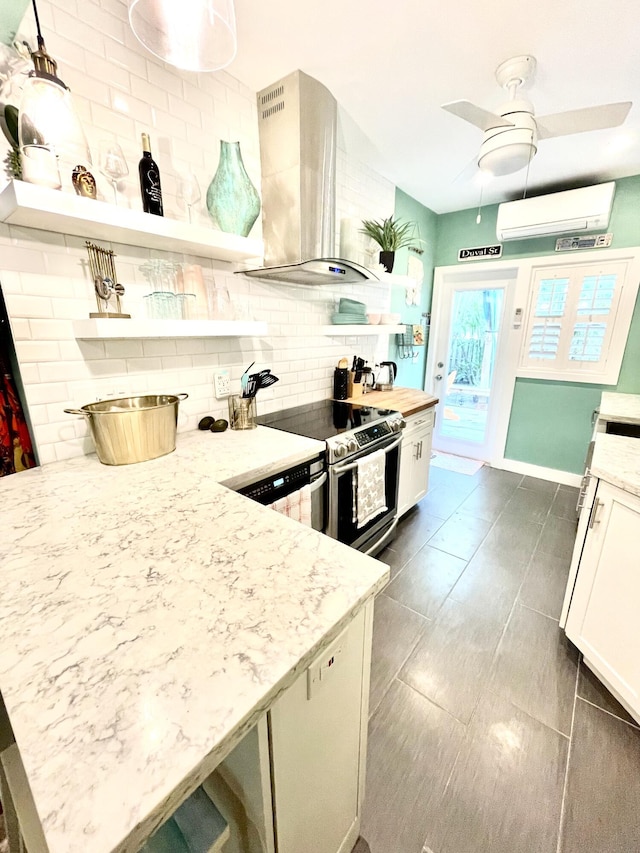 kitchen with a wall unit AC, tasteful backsplash, open shelves, stainless steel range with electric stovetop, and wall chimney exhaust hood