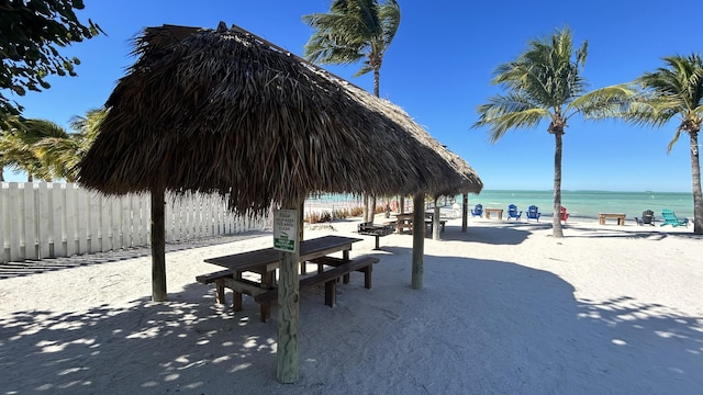 view of property's community with a beach view and a water view