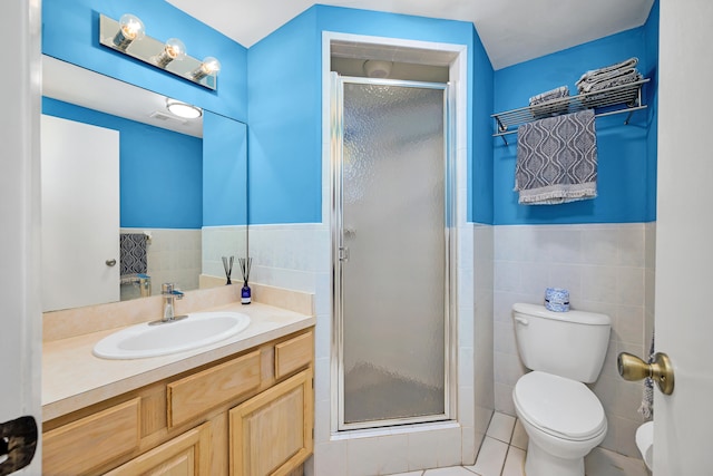 bathroom featuring vanity, tile walls, an enclosed shower, and toilet