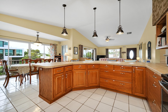 kitchen with pendant lighting, light tile patterned floors, and kitchen peninsula