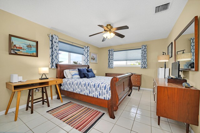 tiled bedroom with a textured ceiling