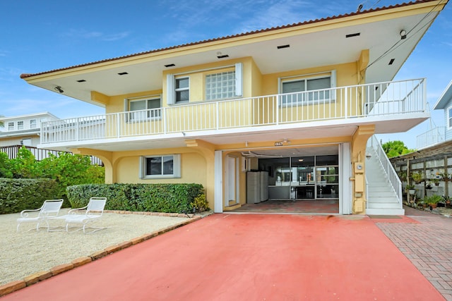 exterior space with a garage and a balcony