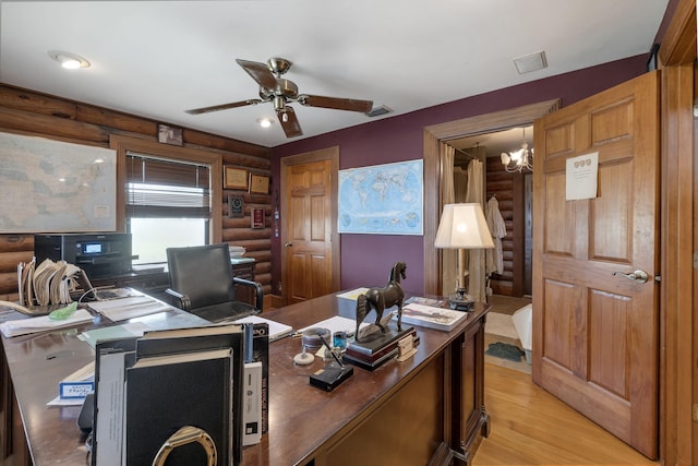 office space featuring ceiling fan, log walls, and light hardwood / wood-style flooring