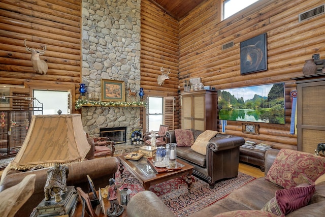 living room featuring a stone fireplace, hardwood / wood-style floors, log walls, and high vaulted ceiling