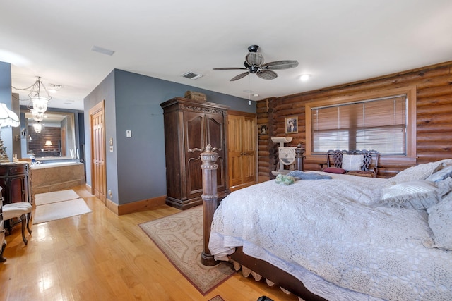 bedroom with rustic walls, ceiling fan, and light hardwood / wood-style flooring