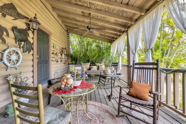 wooden terrace featuring ceiling fan