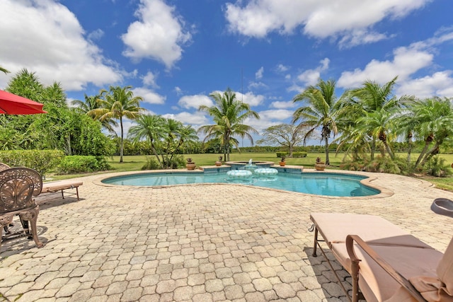 view of swimming pool with a lawn and a patio