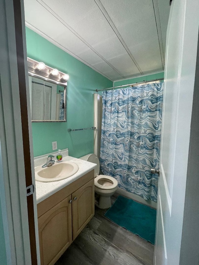 full bathroom with vanity, hardwood / wood-style floors, shower / tub combo with curtain, and toilet